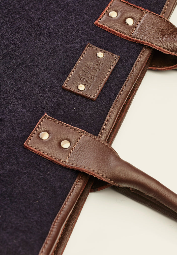 Product - Mini tote - Navy, view of the handle attachment and Honest Wolf logo