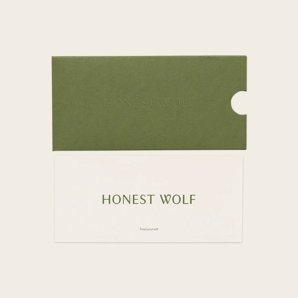 Green and white Honest Wolf Gift Voucher product packaging with 'Honest Wolf' branding on a beige background