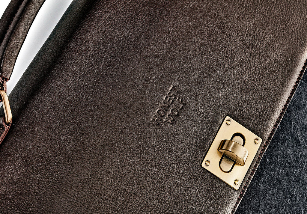 The Briefcase - Midnight/Brown - close up of clasp and logo