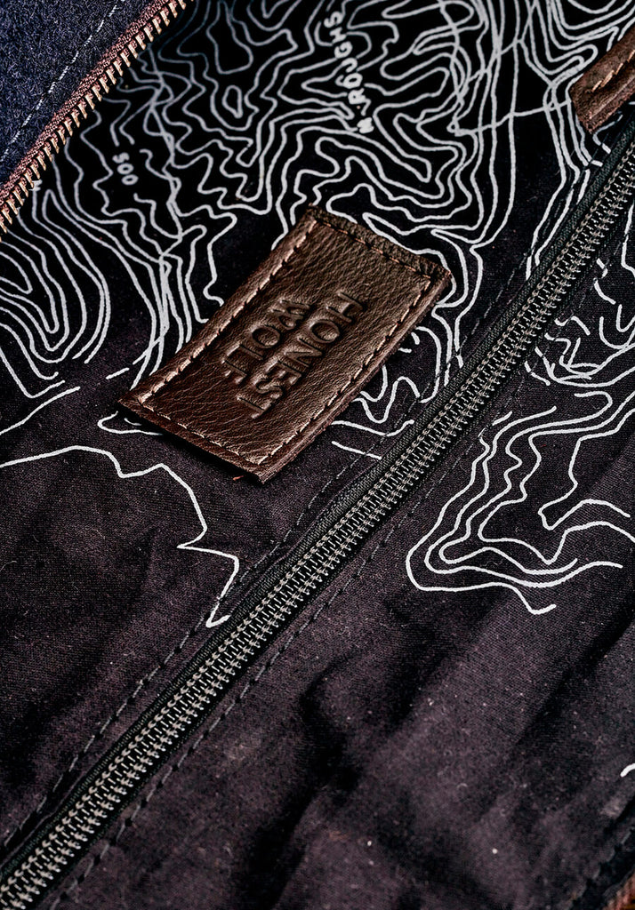 The Overnighter - closeup view of inside lining and logo detail Honest wolf navy wool product 